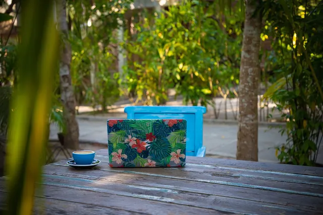 Close-up of a woman typing on a laptop outdoors, focusing on remote work lifestyle.
