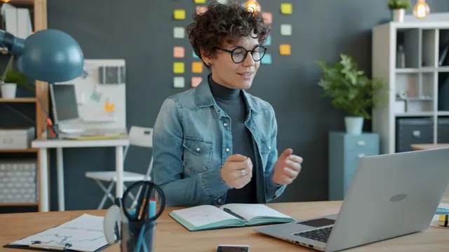 A woman engaging in remote work using a laptop in a stylish office. AI task automation for a virtual assistant agency: three tools compared