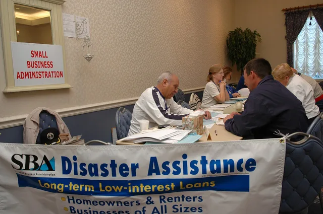 The Villages, Fla., February 6, 2007 -- A Small Business Administration (SBA) representative (left) helps a resident affected by the recent tornadoes with a loan application. The SBA has representatives available at all FEMA Disaster Recovery Centers (DRC). Mark Wolfe/FEMA. The startup budget for a virtual assistant agency and the ways to finance it for owner-operators